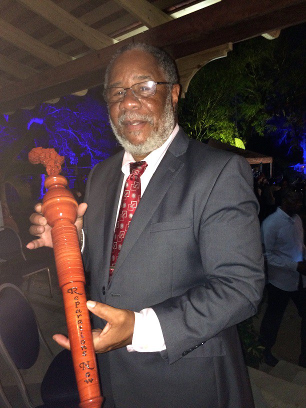 Prof. Pedro Welch, chairman of the Barbados Reparations Task Force, with the Reparations Relay Baton.