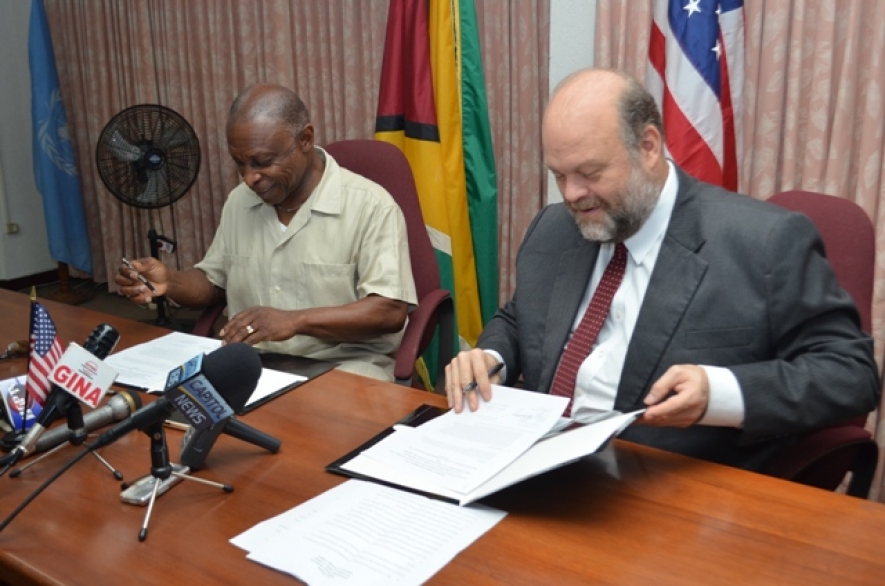 Minister of Foreign Affairs and Vice President Carl Greenidge and US Ambassador Perry Holloway, affixing their signatures to the Caribbean Basin Security Initiative’s (CBSI’s) “Letter of Amendment Three Point Two,” in the Main