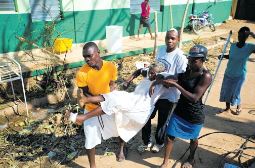 A woman with cholera is carried by residents to a cholera centre in Anse D’Hainault, Haiti on October 11.