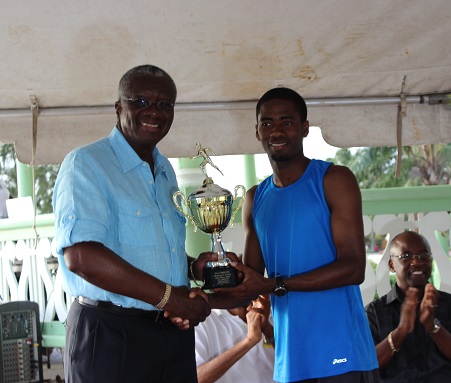 Flashback: CARICOM 10K veteran receives champion&rsquo;s trophy from the Hon Freundel Stuart, Prime Minister of Barbados