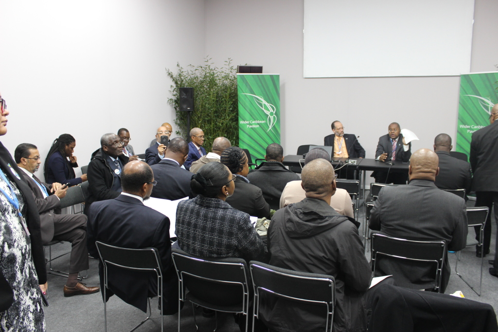 CARICOM negotiators review the draft agreement at COP 21 in France, Wednesday