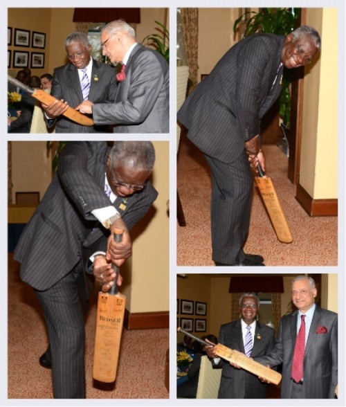Rt. Hon. Freundel Stuart, CARICOM Chairman and Prime Minister of Barbados examines the commemorative cricket bat with Commonwealth Secretary-General Kamalesh Sharma