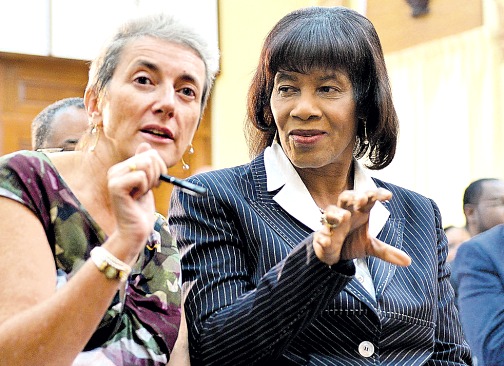 Prime Minister Portia Simpson Miller (right) converses with Head of Delegation, European Union to Jamaica, Paola Amadei, at the launch of the 40th anniversary of Jamaica-EU partnership celebrations, at Jamaica House on Thursday.