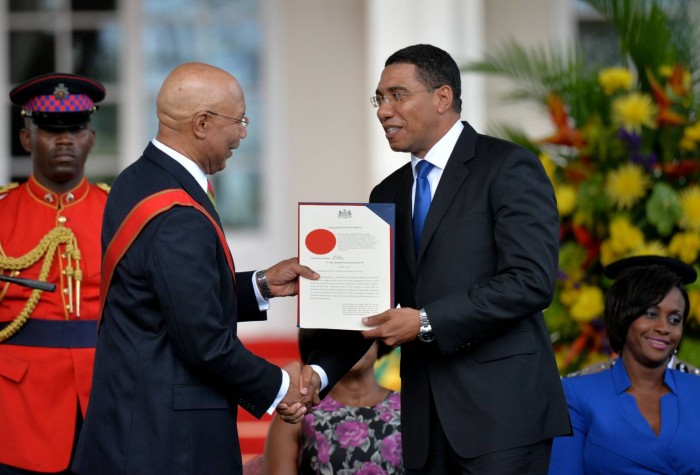 Photo: JIS Photographer Governor-General, His Excellency the Most Hon. Sir Patrick Allen (left), presents the Instrument of Appointment to Prime Minister, Most Hon. Andrew Holness, during Thursday&rsquo;s (March 3) swearing in ceremony, at King&amp;r
