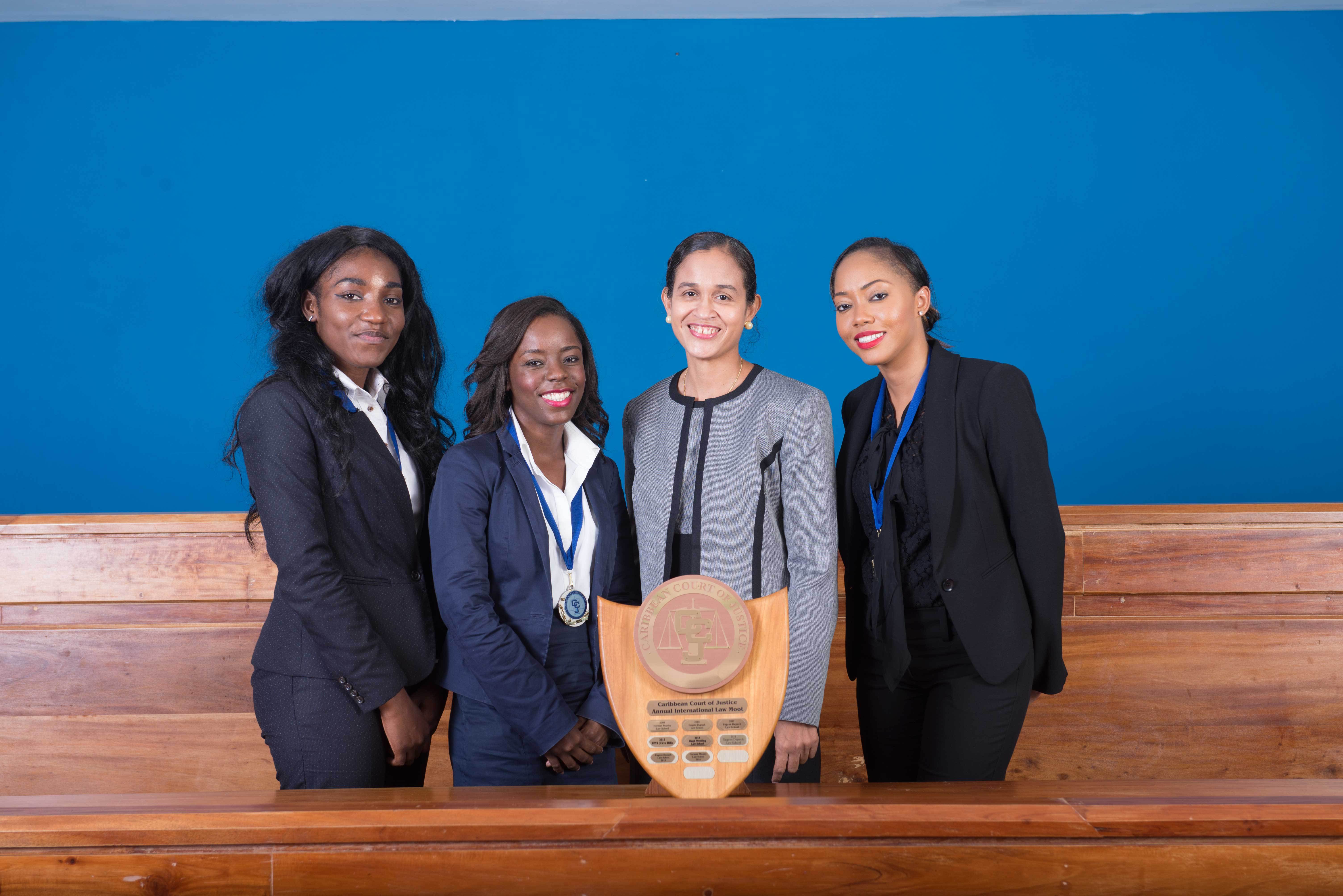 Mrs.	Jacqueline	Graham, (left)	presents	the	award	for	&lsquo;Best	Academic	Institution&rsquo;	to	Team UWI,	Cave	Hill	Campus	(Photos via CCJ) All	female	winning	team	from	the	Eugene	Dupuch	Law	School
