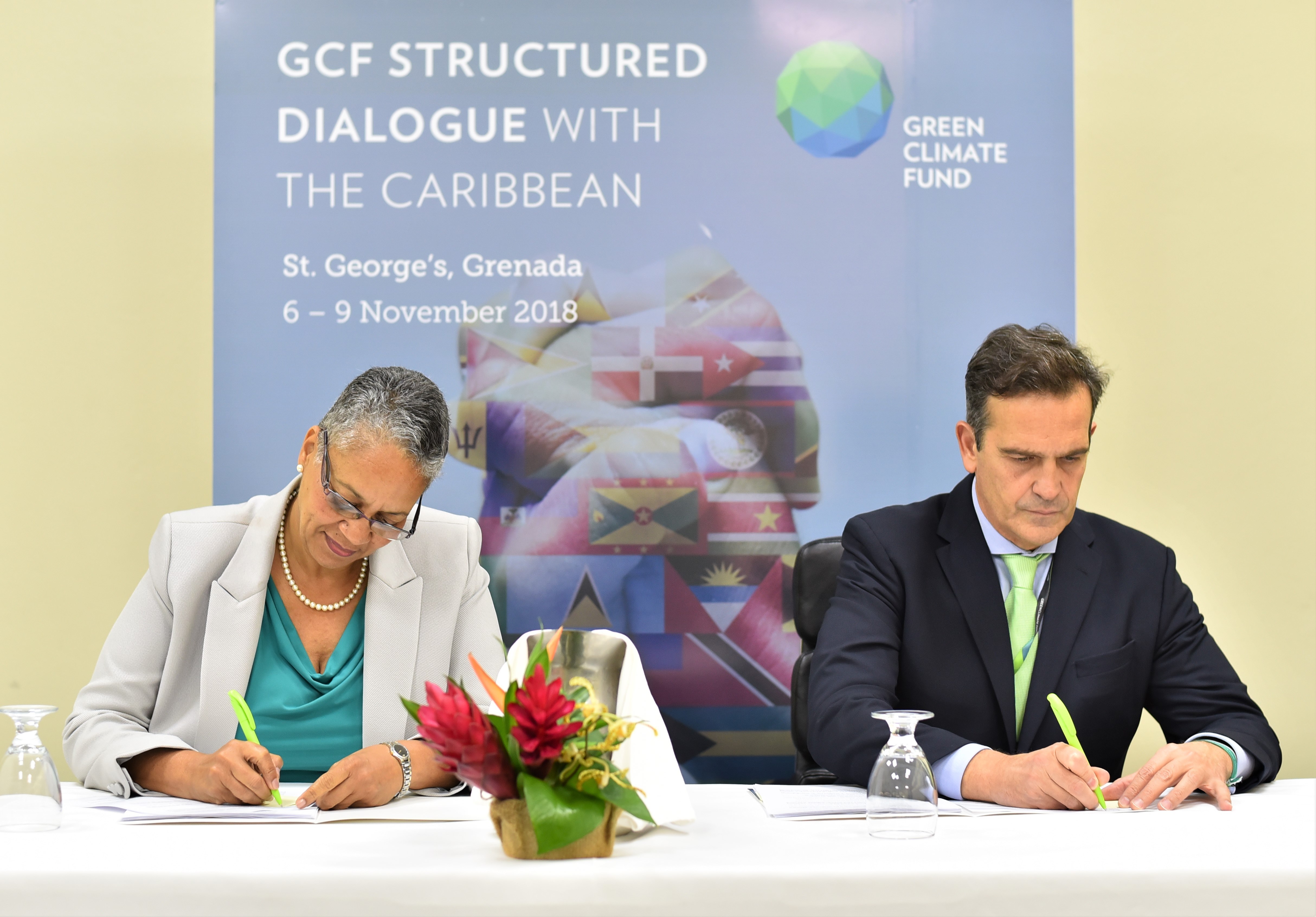 Monica La Bennett, Vice-President (Operations), CDB (left) and Javier Manzanares, Executive Director ad interim (right), GCF sign the AMA in Grenada on November 9, 2018. (Photo
