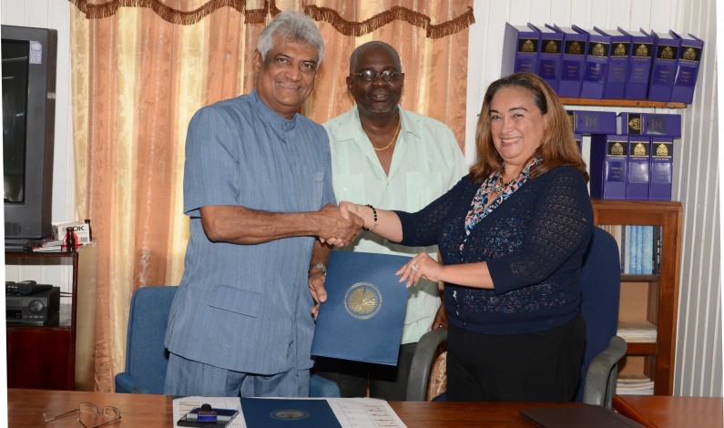 Dr. Steve Surujbally and OAS Chief of Mission, Ms. Lisa Shoman in the presence of Chief Election Officer, Mr. Keith Lowenfield
