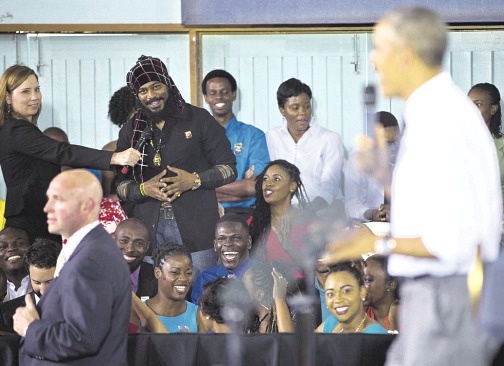 Miguel &lsquo;Steppa&rsquo; Williams (left, standing) asks US President Barack Obama (right) a question about the legalisation of marijuana during a town hall meeting at the University of the West Indies in Kingston, yesterday. (PHOTO: AP)