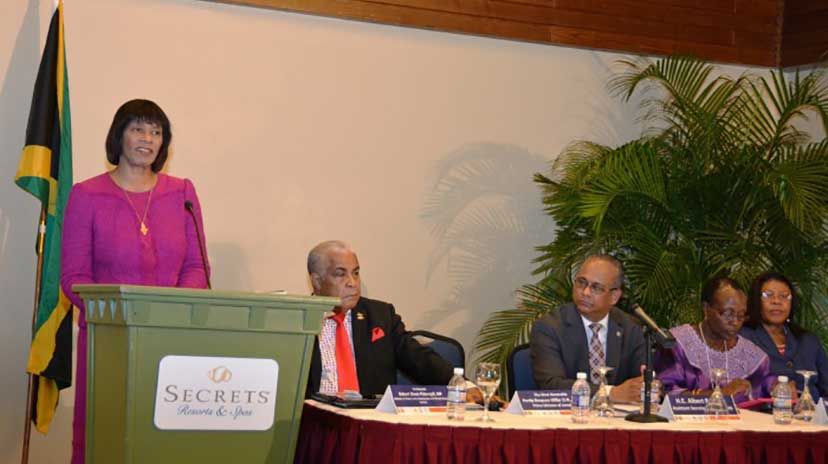 Prime Minister the Most Hon. Portia Simpson Miller (at podium), addressing the opening ceremony of the inaugural Inter-American Congress on the Environmental Rule of Law, at the Secrets Resorts in Montego Bay, St. James, on March 30. Seated at the he