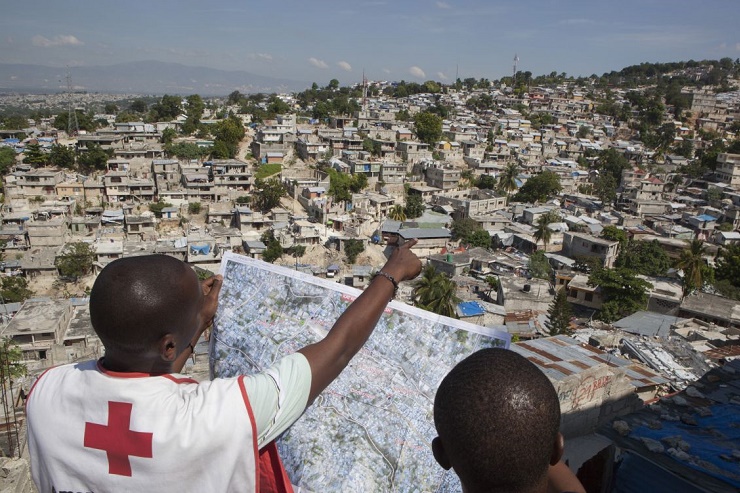 On November 15, 2012, two Red Cross officials review a map of Campeche, a neighborhood targeted by the American Red Cross for a community regeneration project. (Photo: Talia Frenkel/American Red Cross)