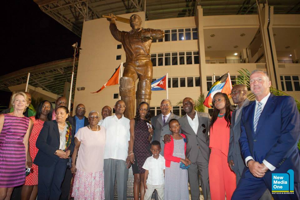 Dr. Timothy Harris standing next to Viv Richards mother along with Cricket Great Ian Bothom PM Baldwin Spencer and family members