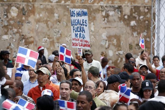 Supporters of Dominican nationalist movements demonstrate in support of the denationalization of thousands of Dominicans of Haitian descent, on Nov. 4, 2013. The sign reads "Ilegal Haitians get out of Dominican Republic." Erika Santelices/A