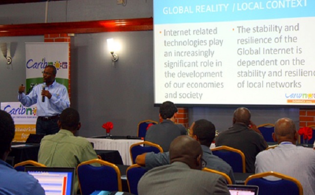 Bevil Wooding, left, one of the founders of CaribNOG, leads a session at the seventh installment of the regional technology development event, held in Roseau, Dominica from April 28 to May 2, 2014 (Photo courtesy CaribNOG)