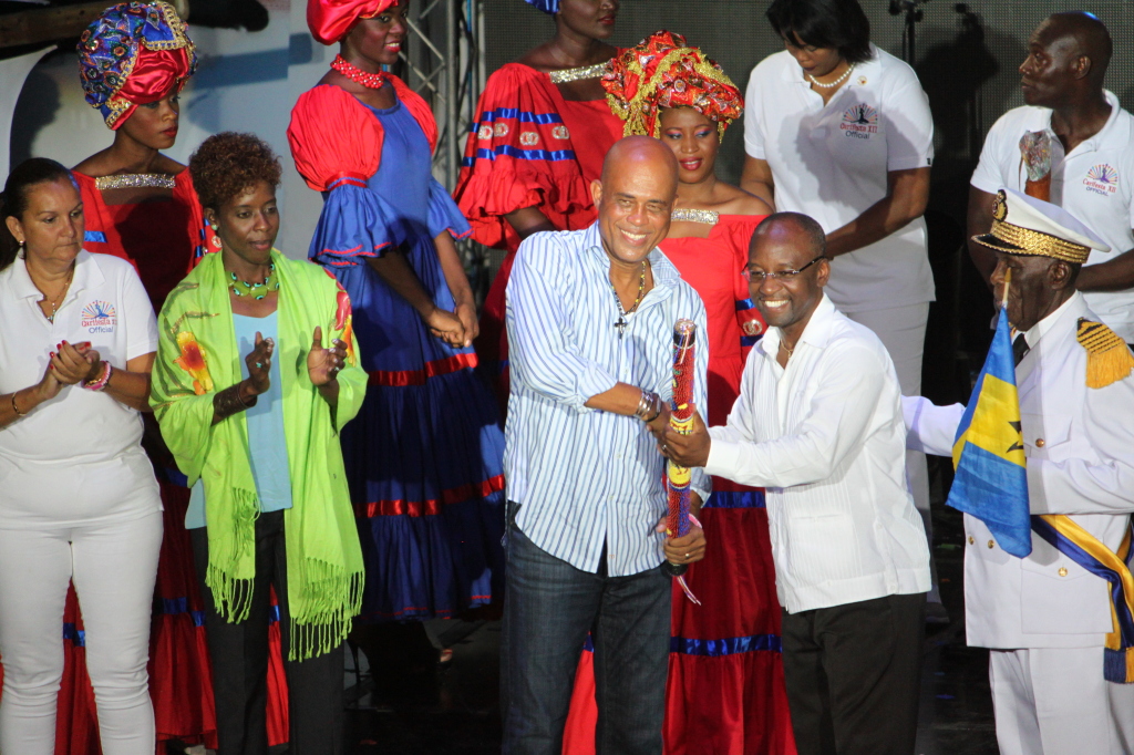 President of Haiti, H. E. Michel Martelly hands over the CARIFESTA baton created by acclaimed Haitian Visual Artist Phillipe Dodard to Barbados Minister of Culture Hon. Stephen Lashley