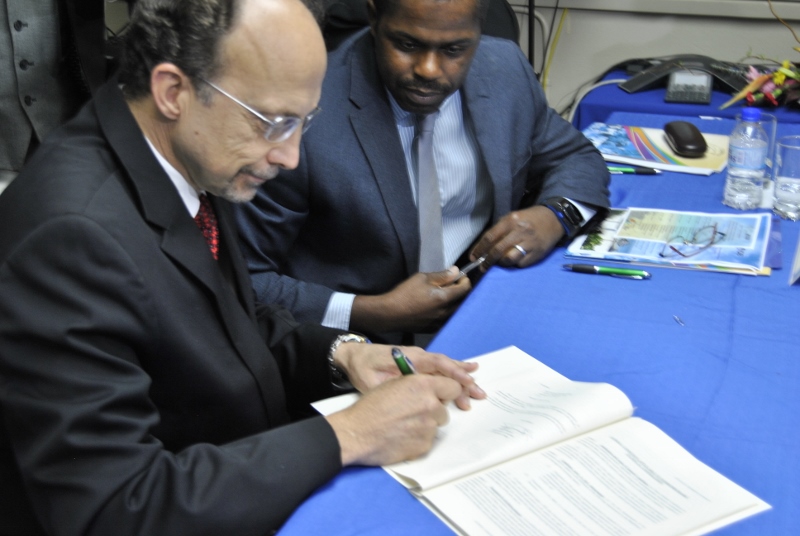 Dr. C James Hospedales, Executive Director CARPHA and Mr. Julian Belgrave, Chief Operations Officer, Trinidad and Tobago IDB Country Office, sign landmark agreement.