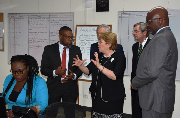 Chile&rsquo;s President, Michelle Bachelet and Executive Director of CDEMA, Ronald Jackson, chatting while on a tour of the Agency&rsquo;s headquarters today. Also pictured is Attorney General and Minister of Home Affairs, Adriel Brathwaite (right).
