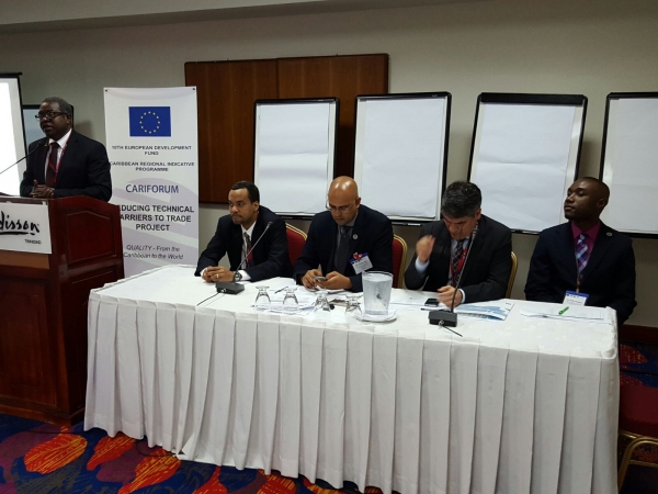 CEO of the Trinidad and Tobago Bureau of Standards, Mr. Theodore Reddock (standing) addressing participants at the opening of Caribbean Conformity Assessment Week. Looking on from left are, Mr. Robert Medford of the Grenada Bureau of Standards; Mr. D