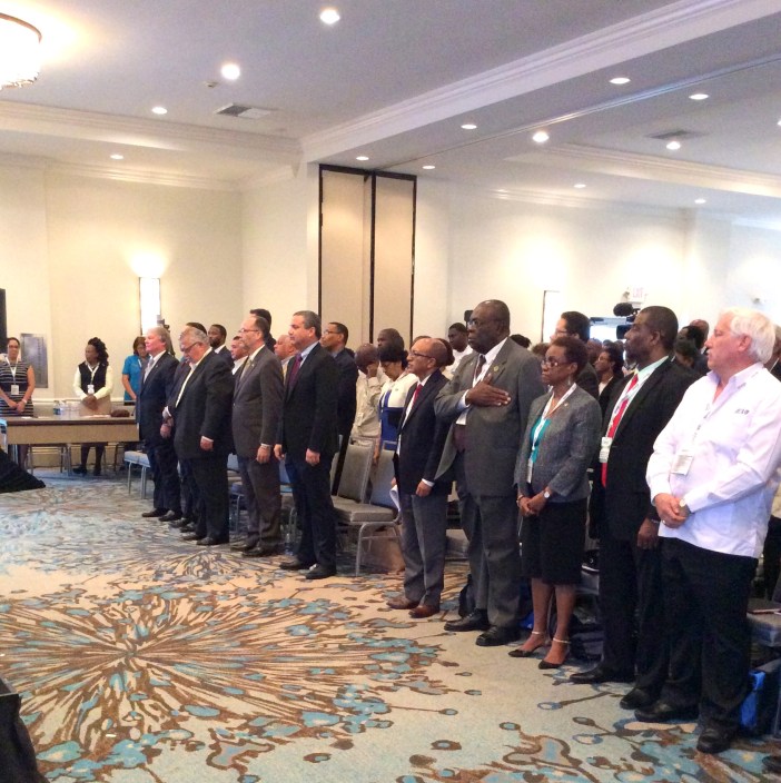 Delegates stand as the CARICOM song was played at the Opening Ceremony of the Caribbean Week of Agriculture 2016, at the Westin Resort, Grand Cayman, Cayman Islands