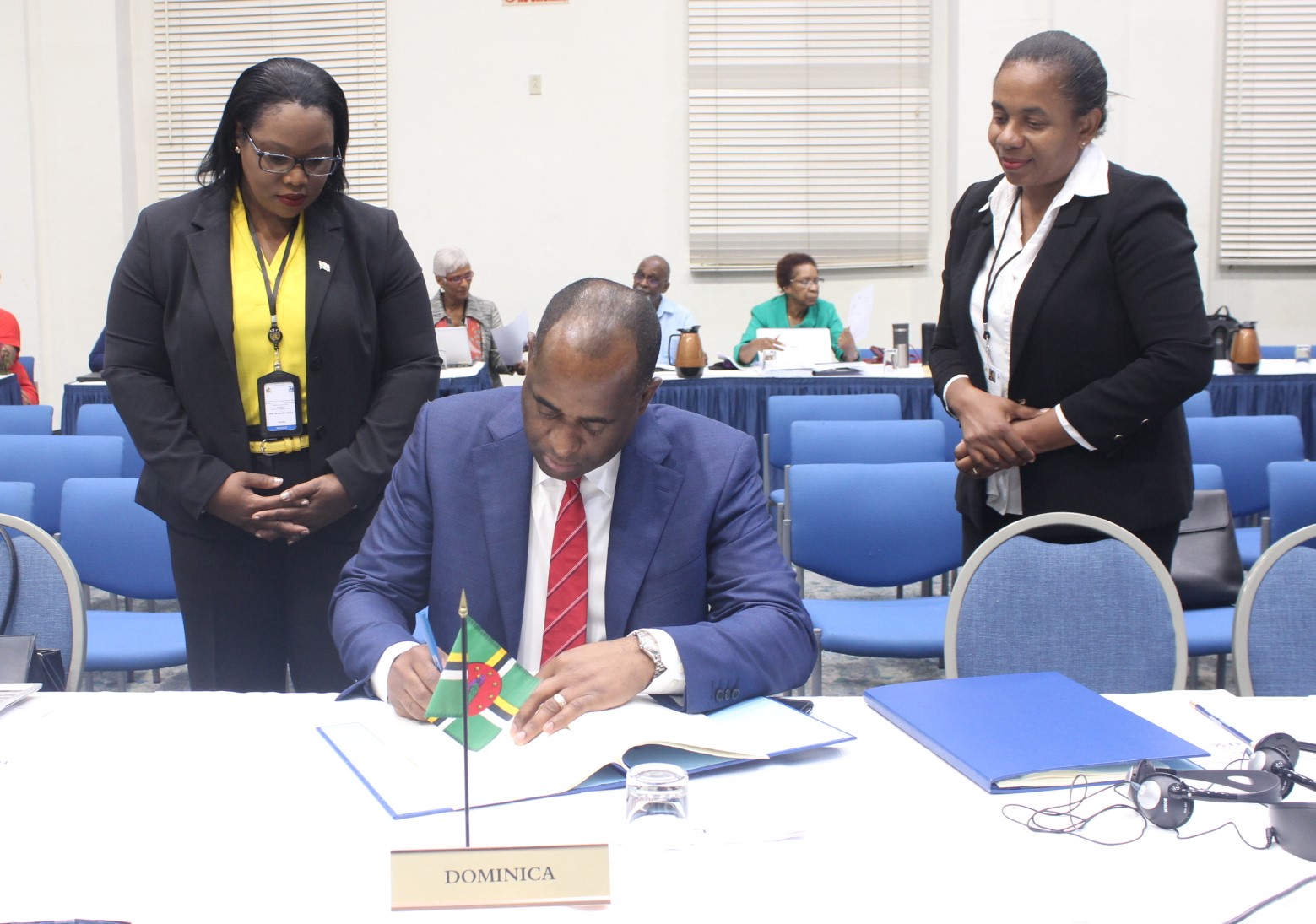 Prime Minister of Dominica, the Hon. Roosevelt Skerrit signs one of the agreements