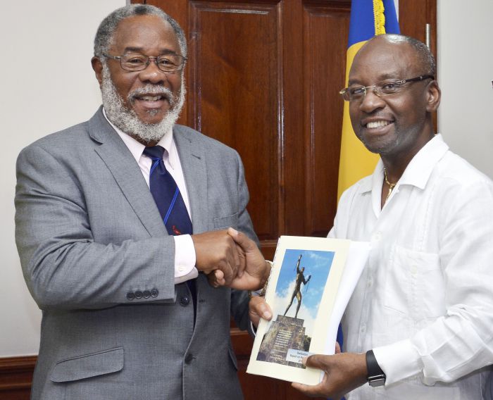 Chairperson of the Reparations Task Force, Professor Emeritus, Pedro Welch presents Minister of Culture, Sports and Youth Stephen Lashley, with a copy of the report on reparations. (W.Alleyne Associates/BGIS)