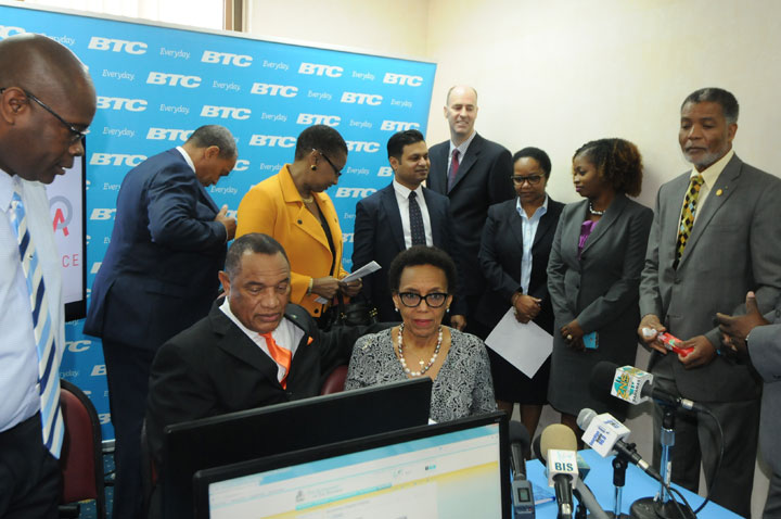 Prime Minister the Rt. Hon. Perry Christie (seated) and Attorney General Senator the Hon. Allyson Maynard Gibson review the new E-Services technology at the Registrar General&rsquo;s Department, January 5, 2016 during launch of the E-Services facilit