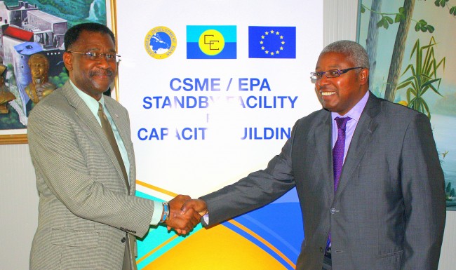 Division Chief, Technical Cooperation Division, Edward Greene (right) shakes hands with Jude Hervey Day, Haiti&rsquo;s Minister of Commerce and Industry, during their talks in Haiti on Tuesday, August 25, 2015.