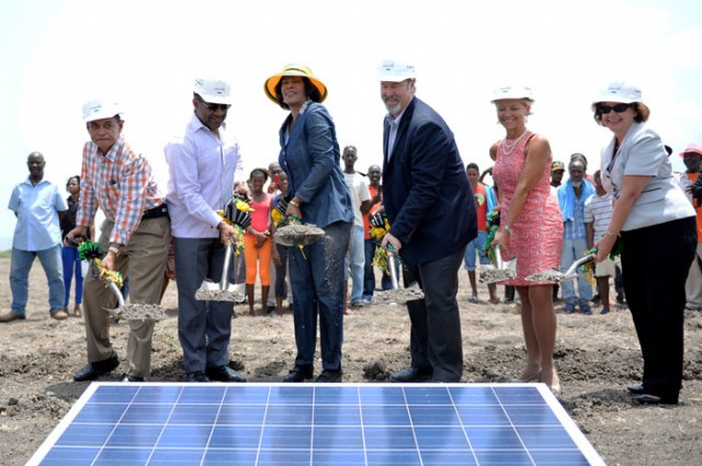 Photo: JIS Photographer Prime Minister, the Most Hon. Portia Simpson Miller (4th right), participates in the breaking of ground for a US $61 million solar electricity plant, at the project site in Content District, Clarendon on July 9. Others (from l