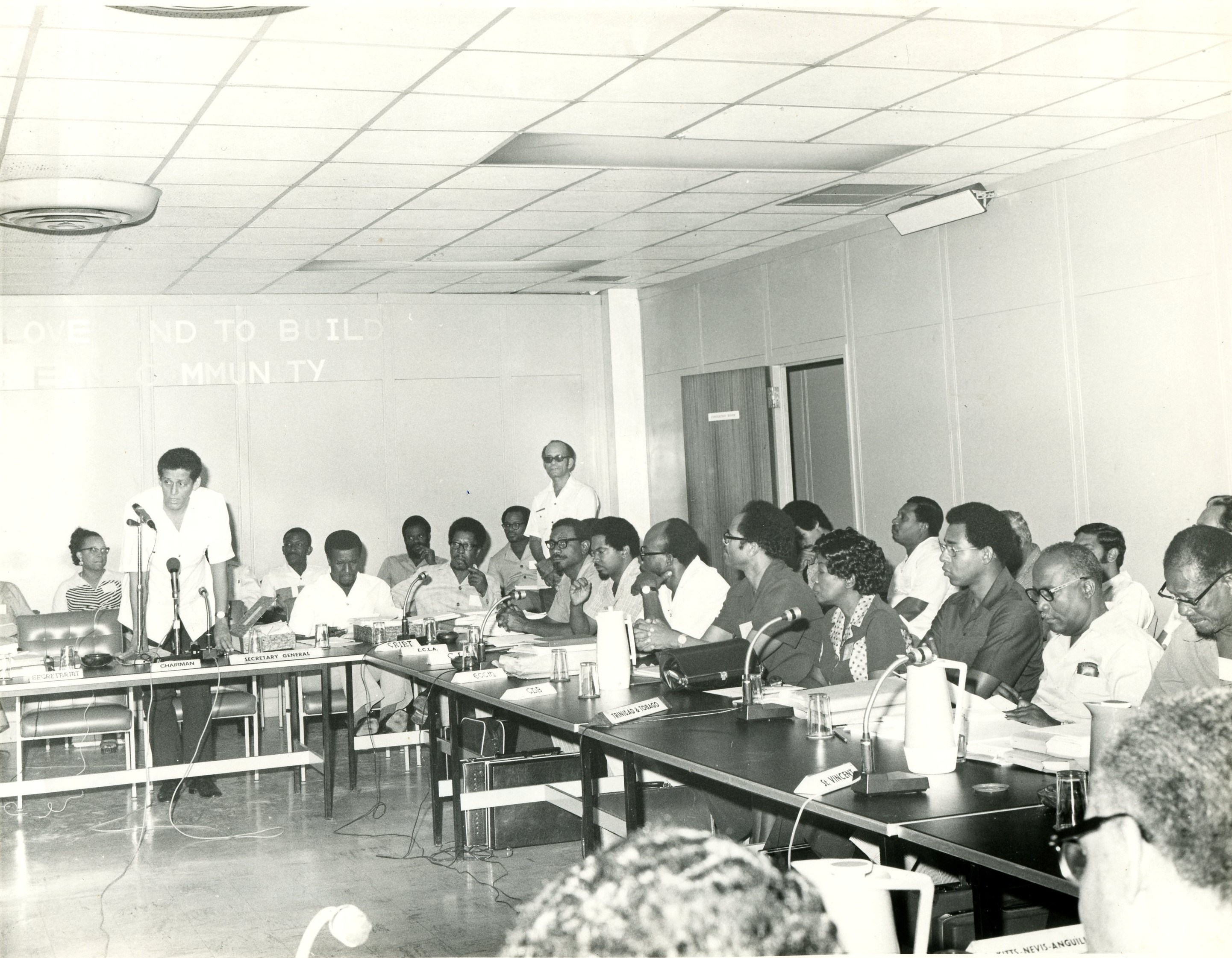 Grenadian, Sir Meredith Alister McIntyre, (standing in front of microphones) CARICOM Secretary-General from 1974-1977