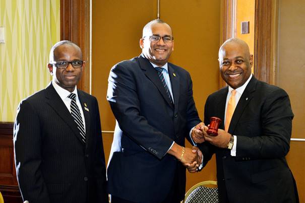 New CTO Chairman Obie Wilchcombe of the Bahamas (right) receives the gavel from his predecessor Richard Sealy of Barbados. Also in photograph, CTO secretary general Hugh Riley (Right) (Photo via CTO)