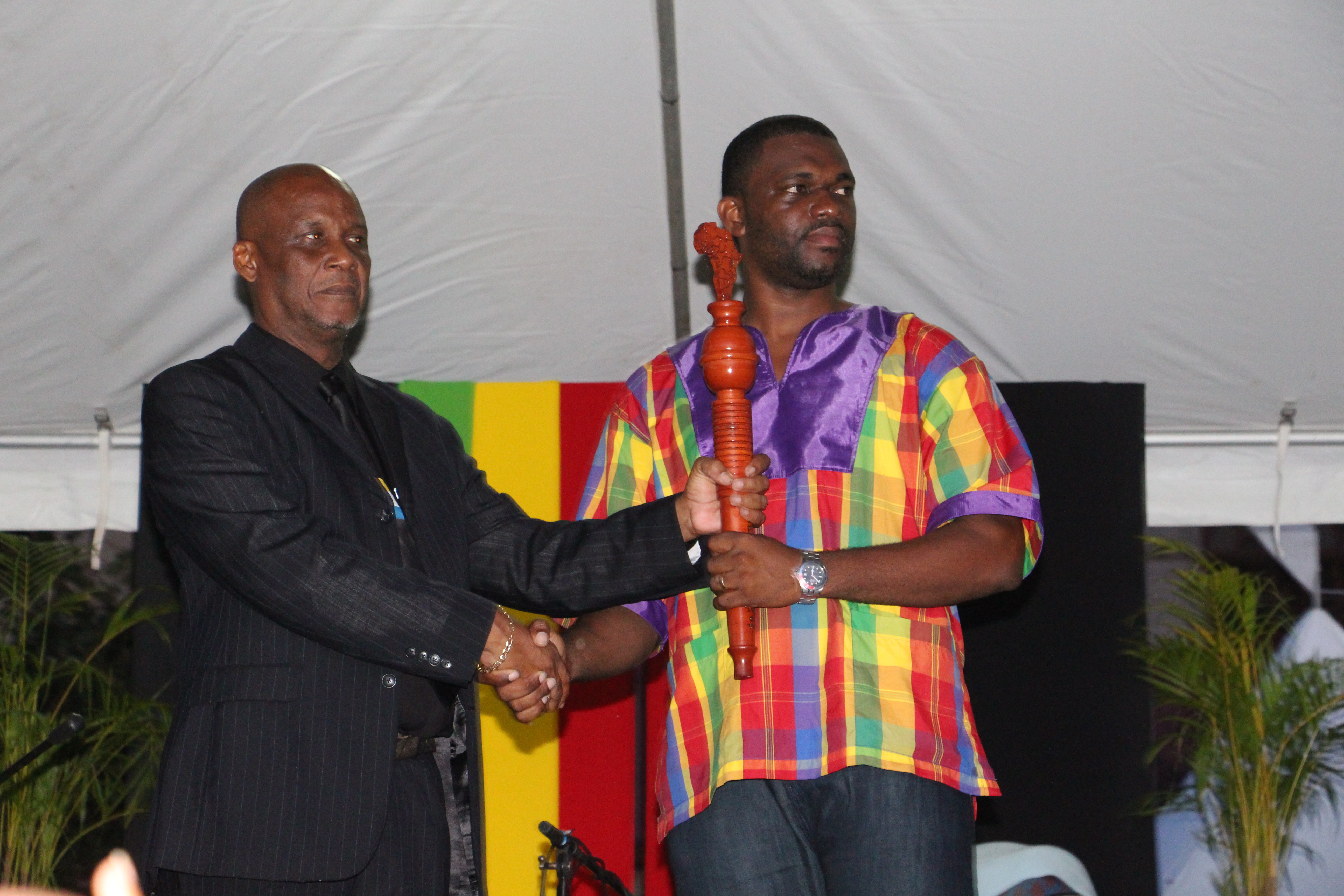 CARICOM Youth Ambassador Charde Dessir accepts the Reparations baton from Mayor of Castries His Worship Peterson Francis