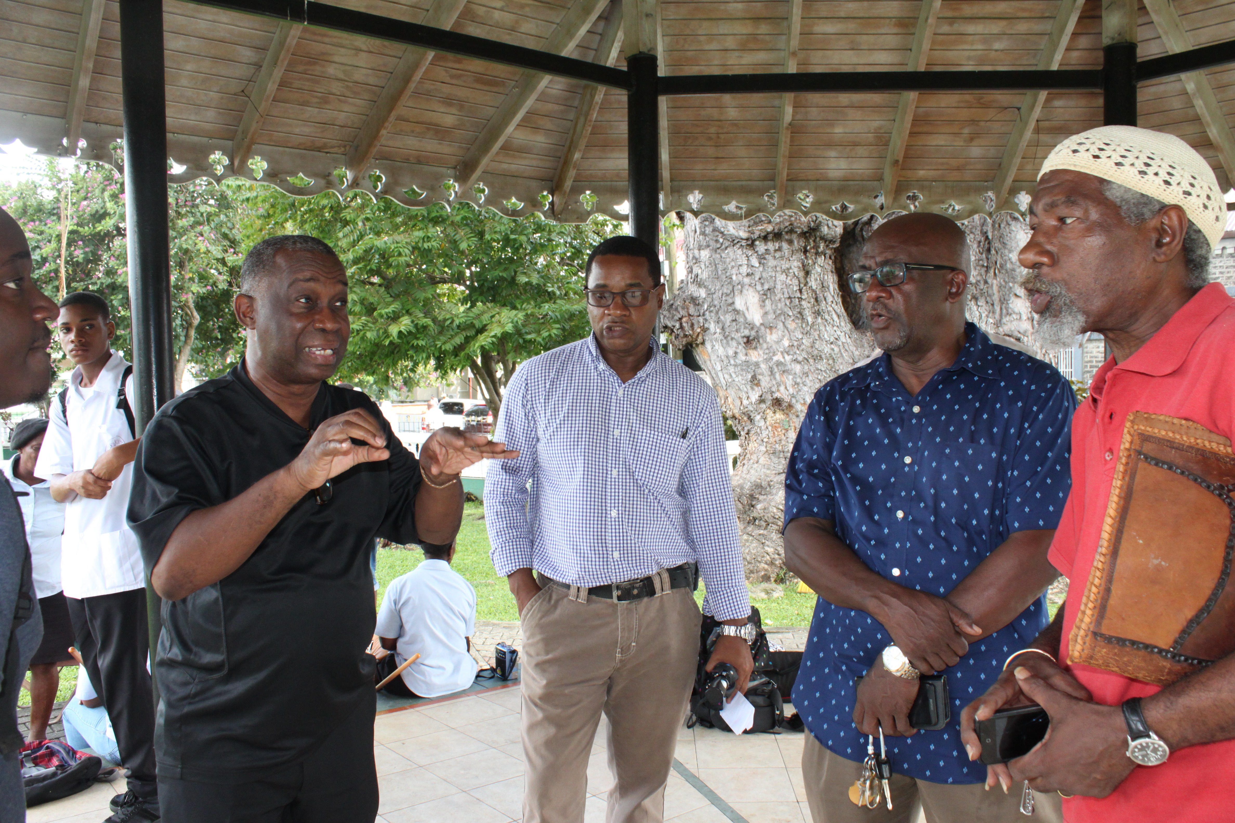 Members of the team discussing logistics at the Derek Walcott Square