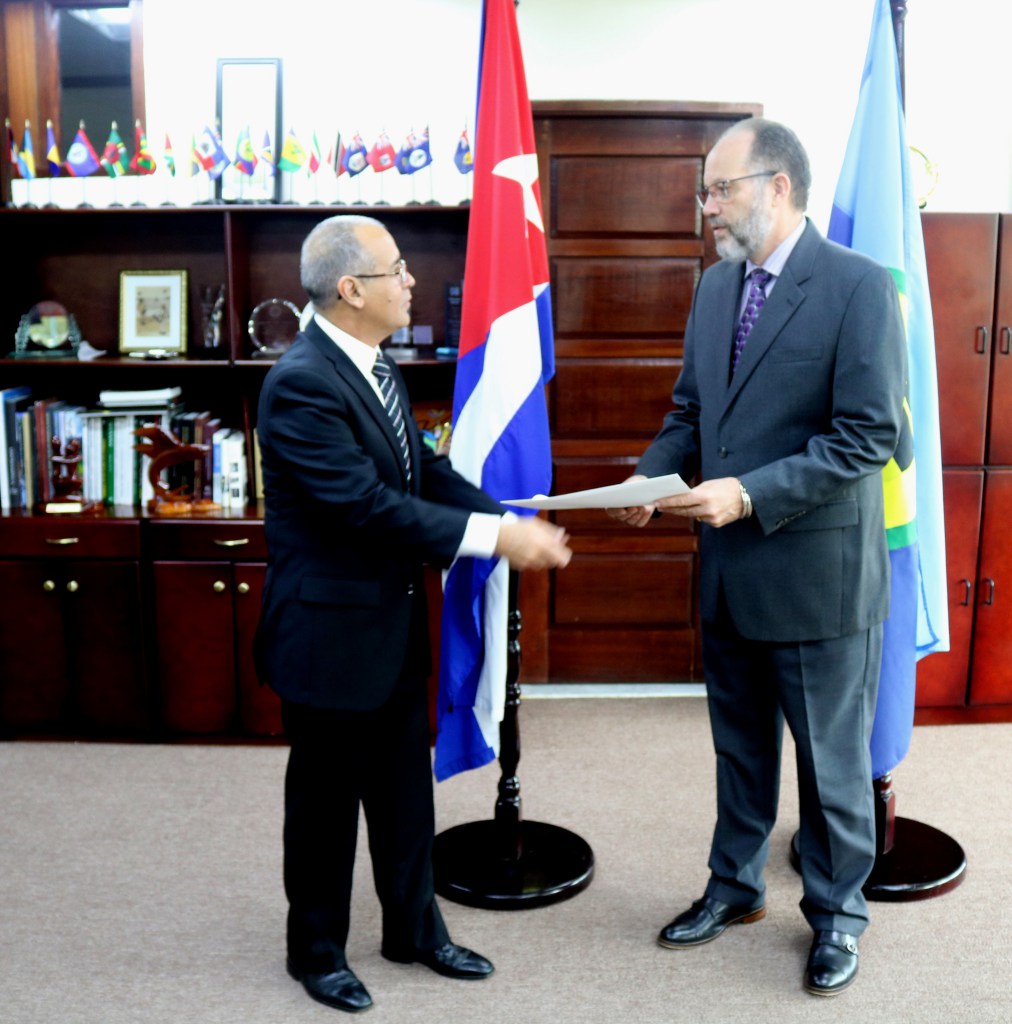 CARICOM Secretary-General, Ambassador Irwin LaRocque (right) accepts the Letter of Credence of His Excellency Narciso Reinaldo Amador Socorro, new Plenipotentiary Representative of Cuba to CARICOM