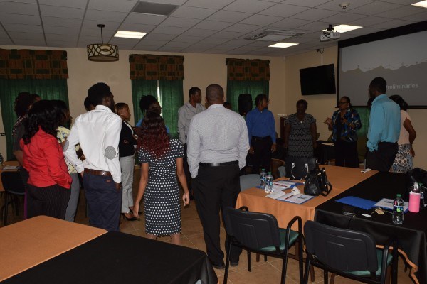 Staff members turn their attention to Mrs. Gray-Phillip as she interacts with them during an icebreaker session. (Photo via SKNIS)