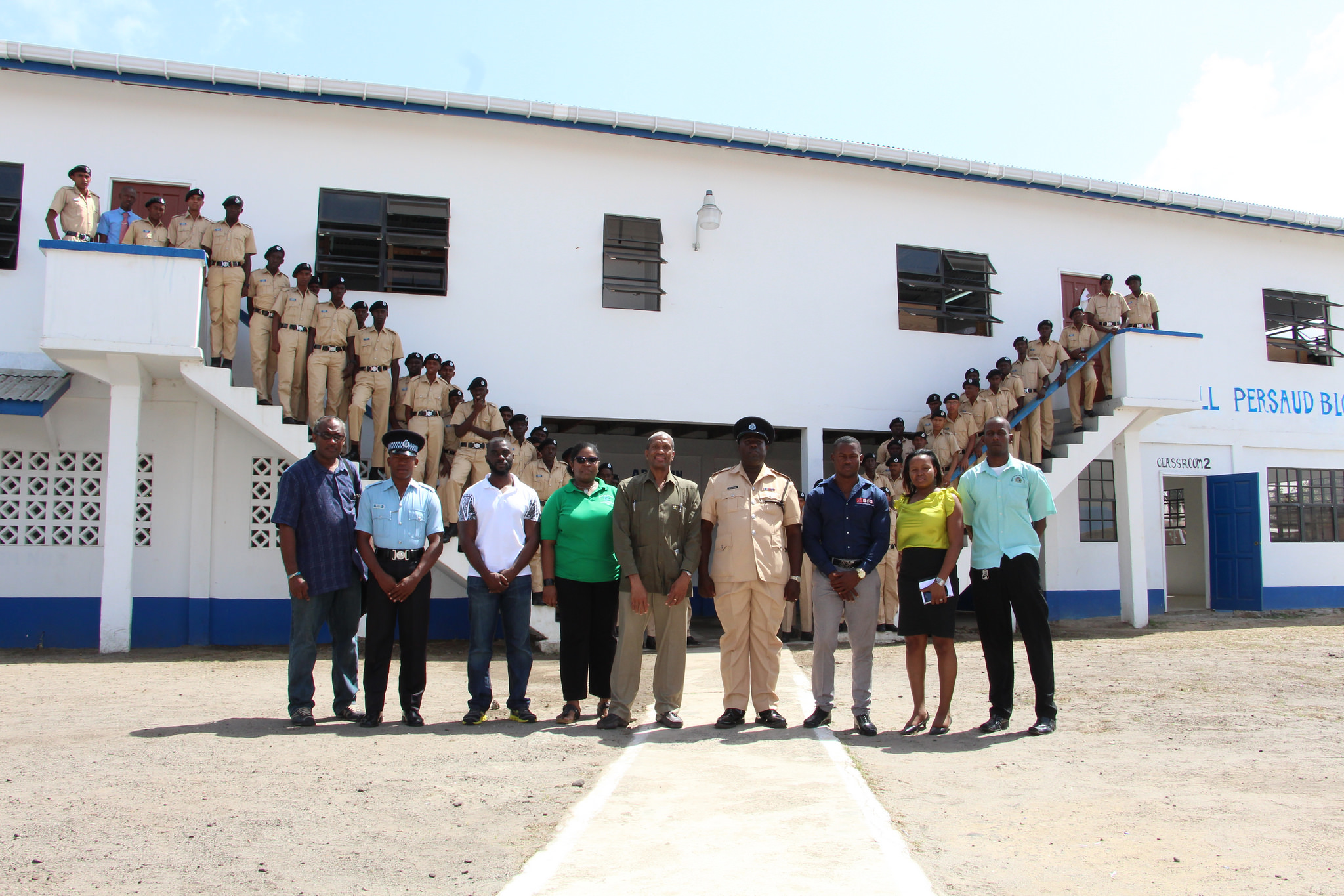 Dr. Douglas Slater, Assistant Secretary-General, Directorate of Human and Social Development (centre) and team, along with Mr. Alex Foster and members of the Felix Austin Police Training College, 'B' Division, Adventure Village, East Berbic
