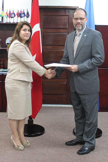 The newly accredited envoy of Turkey to CARICOM, Ambassador Sul&eacute; Oztun&ccedil; (L) presents her Letters of Credence to the CARICOM SG, Ambassador Irwin LaRocque(R)